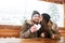 Couple kissing and holding heart made of snow in winter
