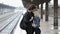 Couple kissing and hugging in train station on rainy day before separation