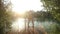 Couple kissing and jumping into water from river dock