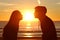 Couple kissing sun with love at sunset