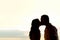 Couple kissing at sunset backlit