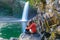 Couple kissing under the Bassin La Paix waterfall in Reunion Island