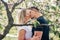 Couple kissing under blooming cherry tree