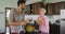 Couple In Kitchen Drink Orange Juice In Morning, Young Man And Woman Talking Breakfast