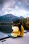Couple by the lake watching sunset, Pyramid lake Jasper during autumn in Alberta Canada, fall colors by the lake during