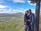 Couple of Latin adult man and woman enjoy the mountainous view of vineyards from a viewpoint you can see the land planted with vin