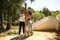 Couple of latin lovers leaning on a wooden poster forming a heart with their hands. The man is camouflaging the woman to make her