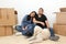 Couple of Latin man and woman move house thanks to a real estate agency they are happy for the beginning of a new life together an