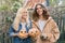 Couple of laughing teenagers with halloween pumpkins having fun