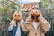 Couple of laughing teenagers with halloween pumpkins having fun