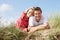 Couple laying on sand dunes