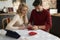 Couple learning to fold Christmas napkins