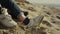 Couple legs playing sand on sea. People shoes moving on romantic nature date.