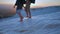 Couple legs walk down in the flowing water in Pamukkale