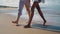 Couple legs walking beach closeup. Relaxed slim girls enjoying going ocean shore