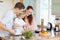 Couple letting their child stir the salad