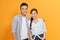 Couple life partners perfect match isolated over yellow color background