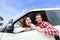 Couple lifestyle in new car looking out window