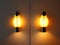 A couple of lights that are on a wall, ambient amber light.