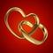 Couple of linked gold wedding rings on red background