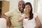 Couple in living room with remote control