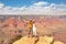 Couple look out on the Grand Canyon