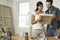 Couple Looking At Canvases In Artist Studio