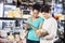 Couple Looking At Cheese Basket In Grocery Store