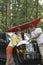 Couple Looking At Map On Car Bonnet In Forest