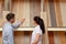 Couple looking at parquet board for home flooring in store