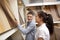 Couple looking at parquet board for home flooring in store