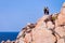 Couple looking at rocks at Capo Testa Sardinia