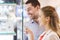 Couple looking to shopping window at jewelry store