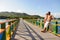 Couple looking towards the ocean, over the Love Bridge at Providencia island, Colombia.