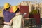 Couple Looking At Unfinished Housing Structure