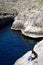 Couple looking at the view at Blue Grotto, Malta.