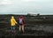 A couple are looking at the wreck of the broken plane