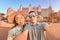 couple in love arrived for their honeymoon in Dubai and takes a selfie in front of their hotel on the island of palm Jumeirah