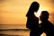 Couple in love back light silhouette on sea