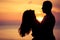 Couple in love back light silhouette on sea