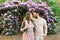 Couple in love on the background of bright flowering rhododendrons look at each other. Valentine`s day