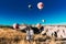 Couple in love among balloons. Happy couple in Cappadocia. Honeymoon in the mountains. Man and woman traveling. Flying on balloons