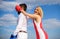 Couple in love boxing gloves blue sky background. Girl close his eyes boxing gloves. Cunning strategy win. Savvy key to