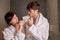 Couple in love brushing teeth in bathroom - concept of complicity and couple life