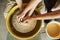 A couple in love creates a joint cup in a pottery workshop. Potter making ceramic pot on the pottery wheel