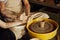 A couple in love creates a joint cup in a pottery workshop. Potter making ceramic pot on the pottery wheel