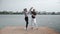 The couple in love dance social dance bachata pier on the lake wide view