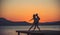 Couple in love dance on sunrise beach. couple in love dance in twilight on pier.