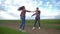 Couple in love dancing in slow motion and enjoy weekend outdoors at countryside on background of sky, happy