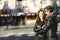 Couple in love embraced in an urban scene, with unfocused background and copy space